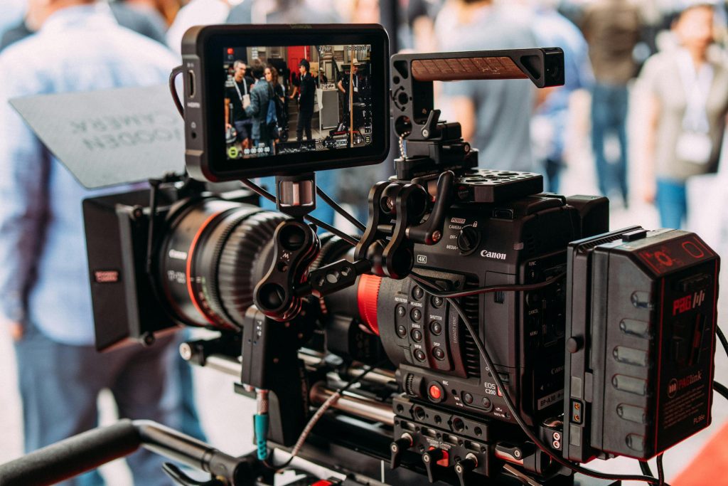 pexels-photo-2443292-2443292 Close-up of a professional video camera setup capturing live footage during an outdoor event.